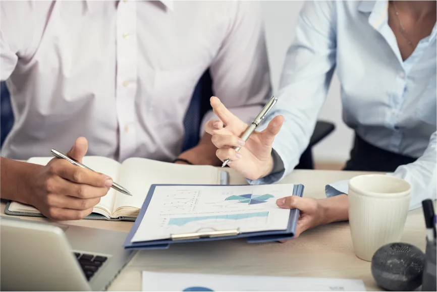 mid-section-unrecognizable-people-formalwear-discussing-statistical-data 1 Maximizing Tax Planning Strategies
