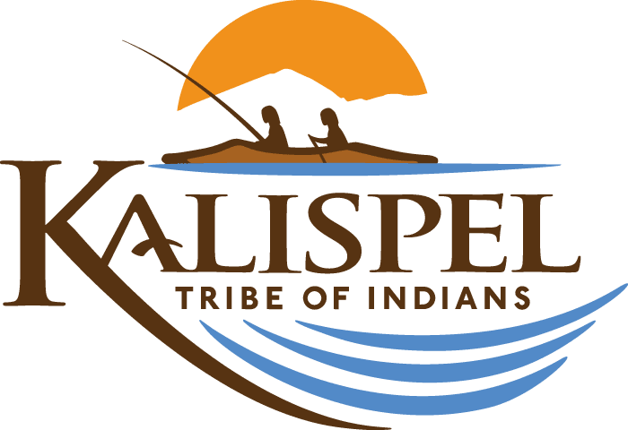 Kalispel_Full-Logo_Color Logo of the Kalispel Tribe of Indians featuring two people in a canoe, a mountain and sun in the background, and blue water waves below the tribe’s name.