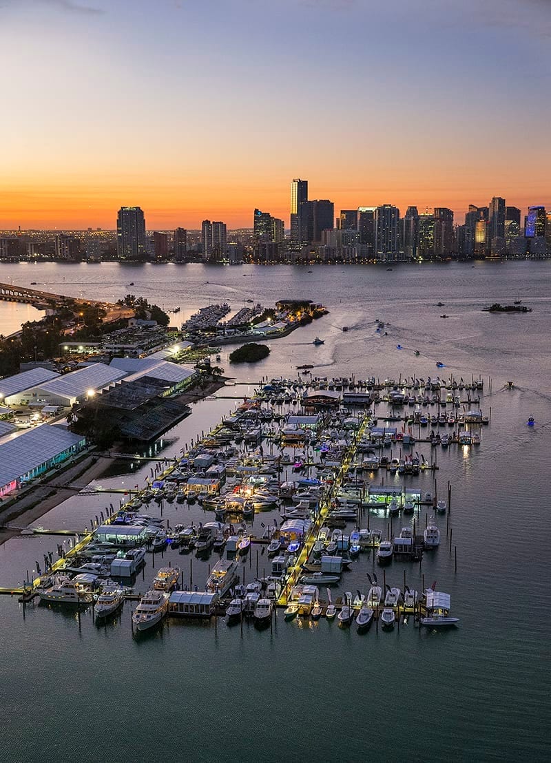 Boats docked at Miami Marina during the Miami Boat Show, showcasing Bellingham Marine construction history in a vibrant setti