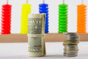 Fixed vs. Variable Annuities: What’s the Difference? 4 rolled dollars coins stack table