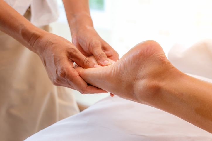 Young woman having foot massage in spa salon, close up Young woman having foot massage in spa salon, close up