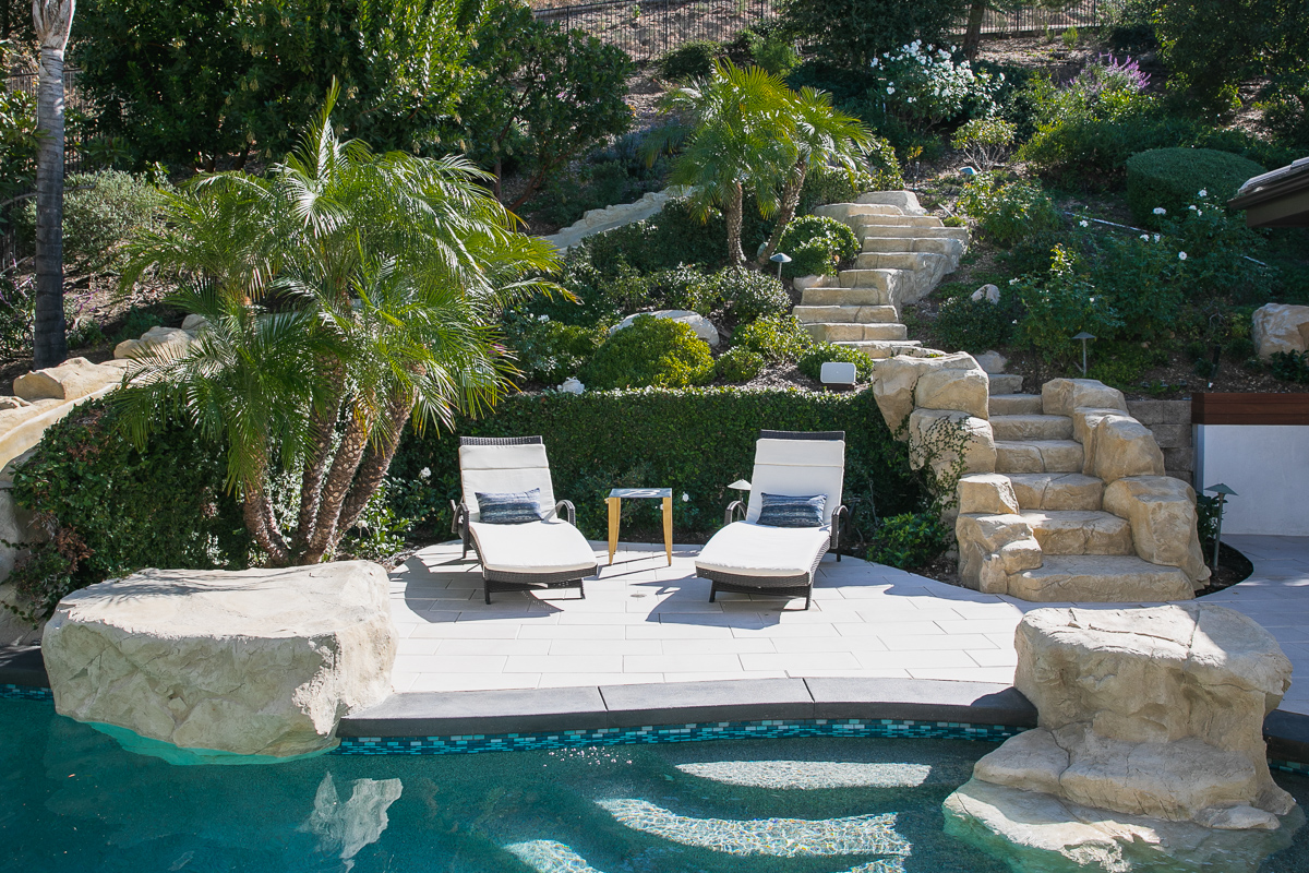 Lounging by the pool Two lounge chairs by the swimming pool
