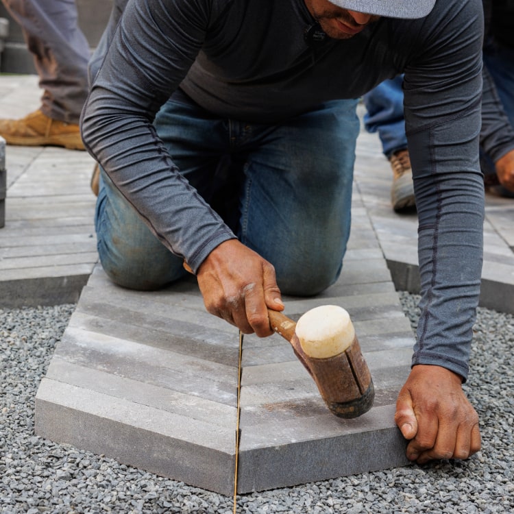 Laying pavers Two men reviewing the construction of a large masonry fireplace