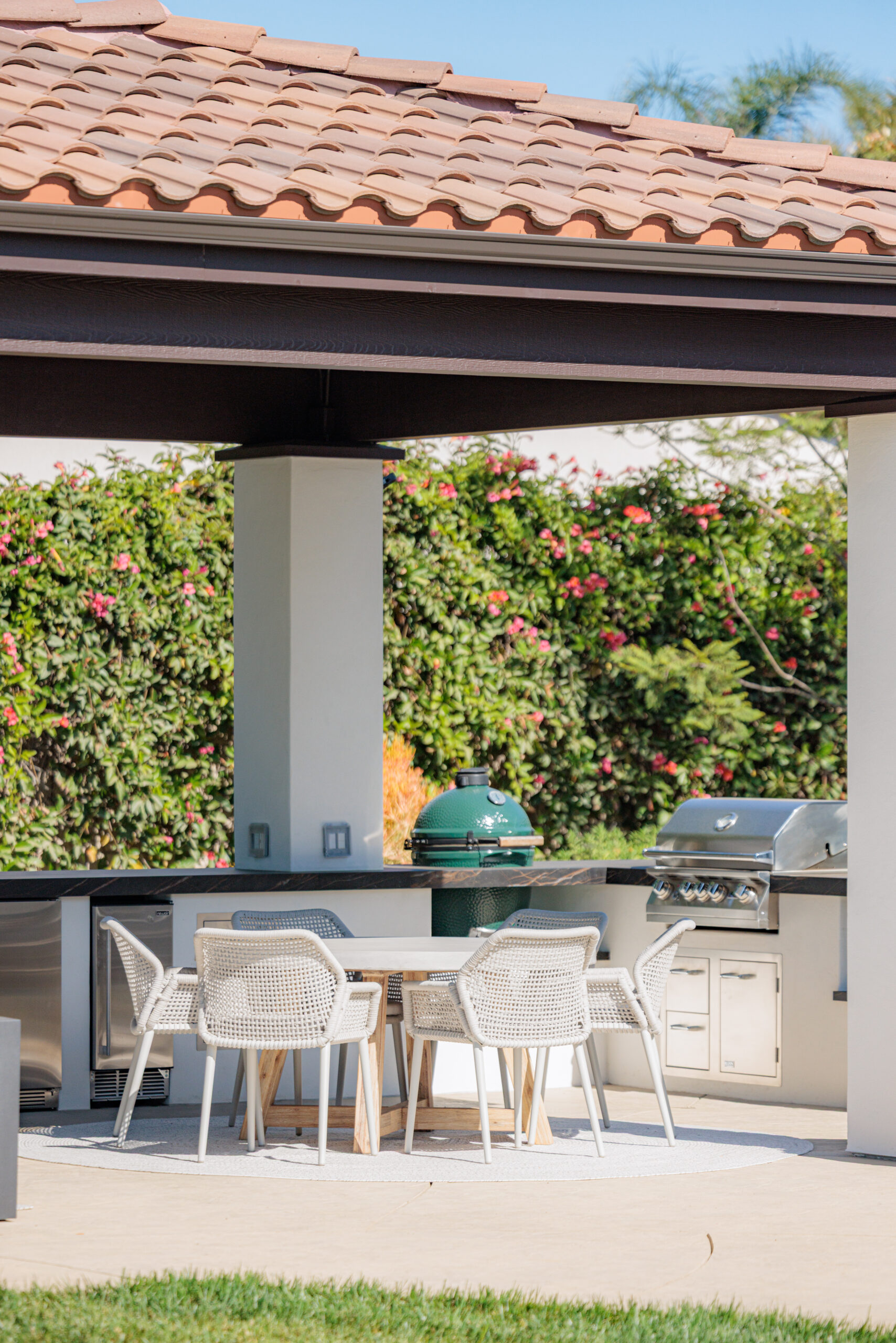 Custom Outdoor Kitchen Design & Build Custom outdoor kitchen with built-in grill, dining table, and covered patio for outdoor living and entertaining.