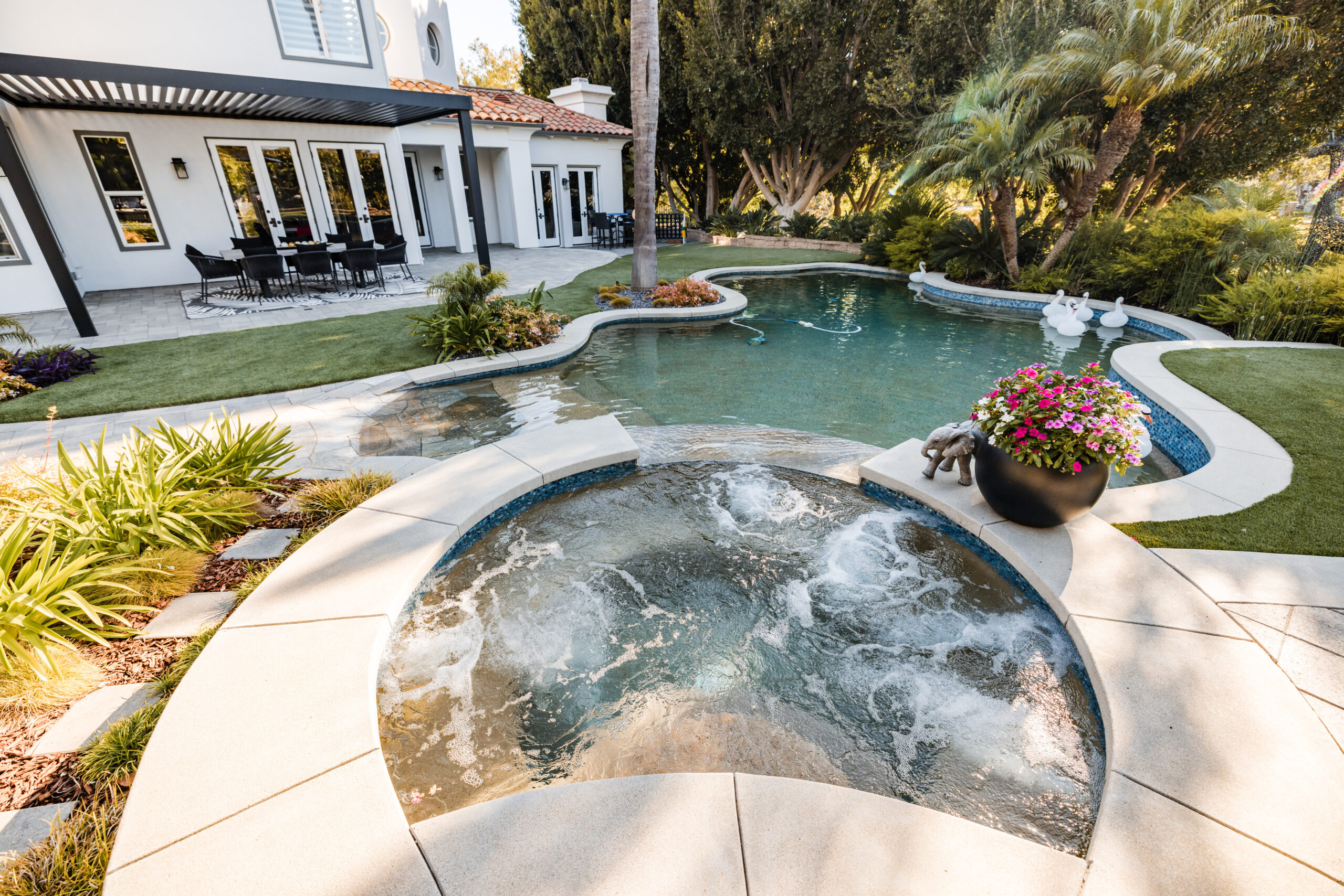 Custom Freeform Pool & Spa in Camarillo Freeform swimming pool and spa with lush landscaping and covered patio in Camarillo, California