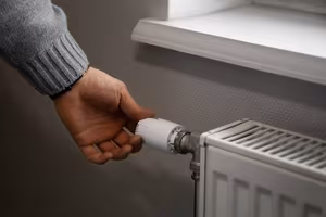 Heating 1 man-turning-off-radiator-during-energy-crisis