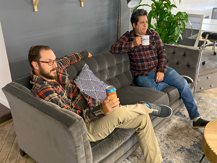 two men sitting down at lounge space at Coworking and Connect