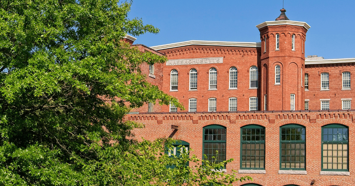 Plumbing problem in a Lowell, MA mill building. Photo shows the front of a brick Mill building.