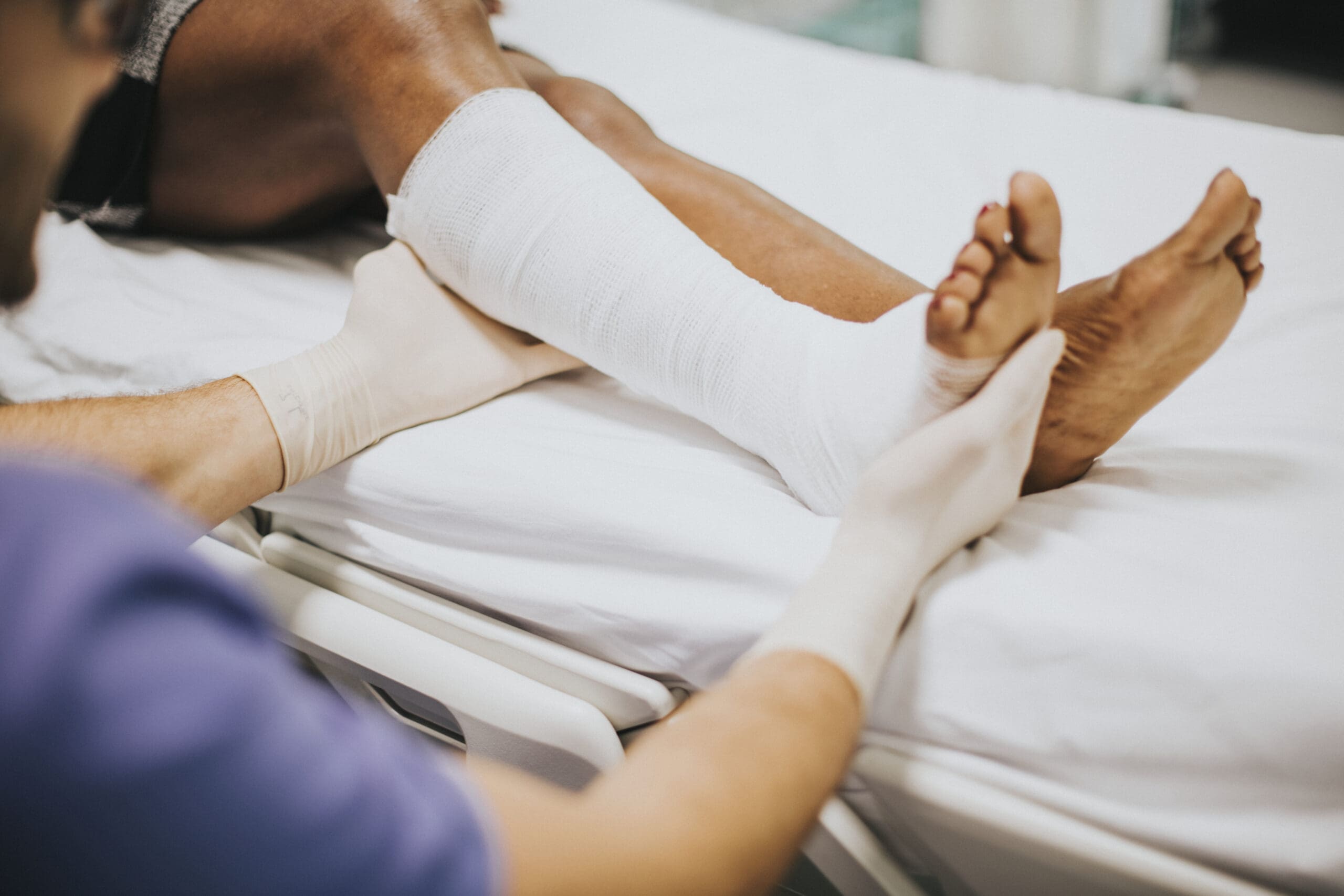 Doctor helping a patient with a fractured leg accident compensation claims