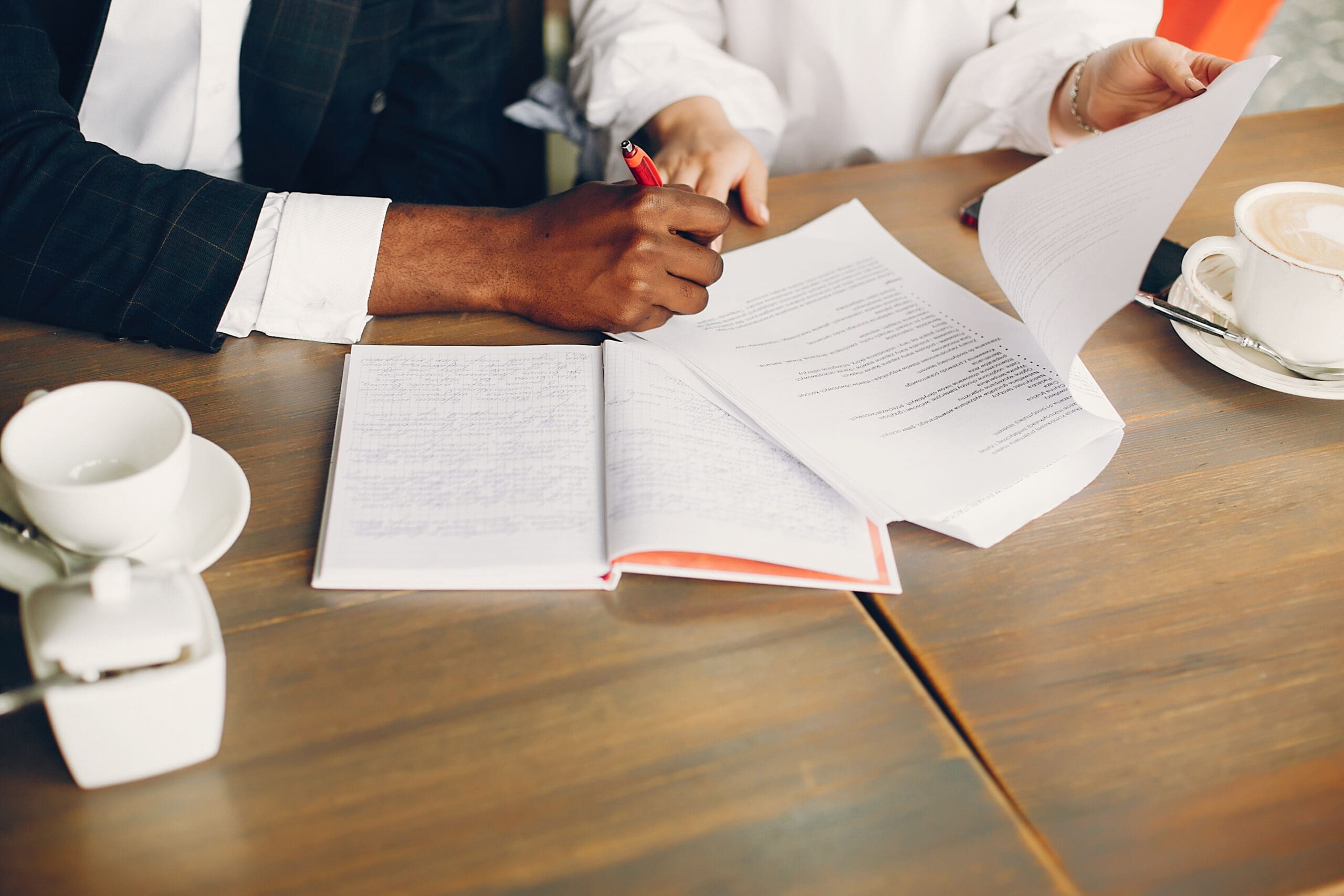 Business partners sitting in a cafe workers compensation lawyer