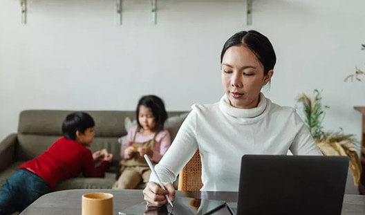 Flexible Working Arrangements Mom working from home to take care of kids