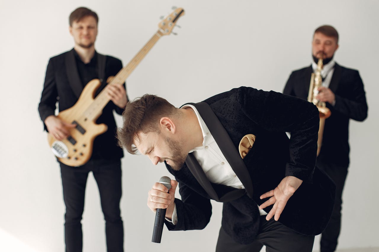 client-satisfaction-img Energetic music band with singer, guitarist and saxophonist performing indoors.