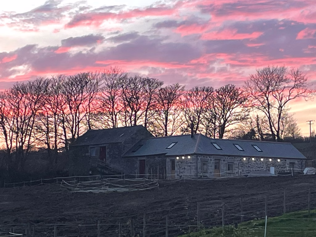 Sunrise over the farm buildings at Noonvares Farm