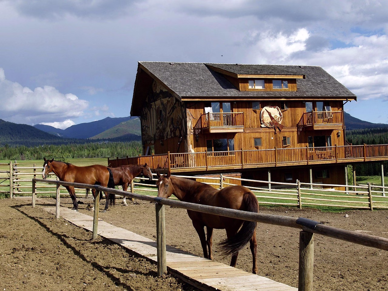 Horses tied outside a log ranch building in British Columbia