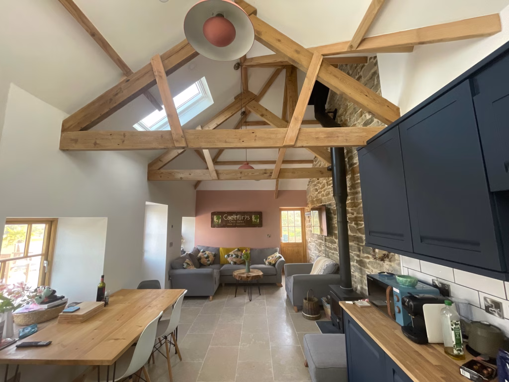 The inside of the holiday cottage, with a vaulted timber roof
