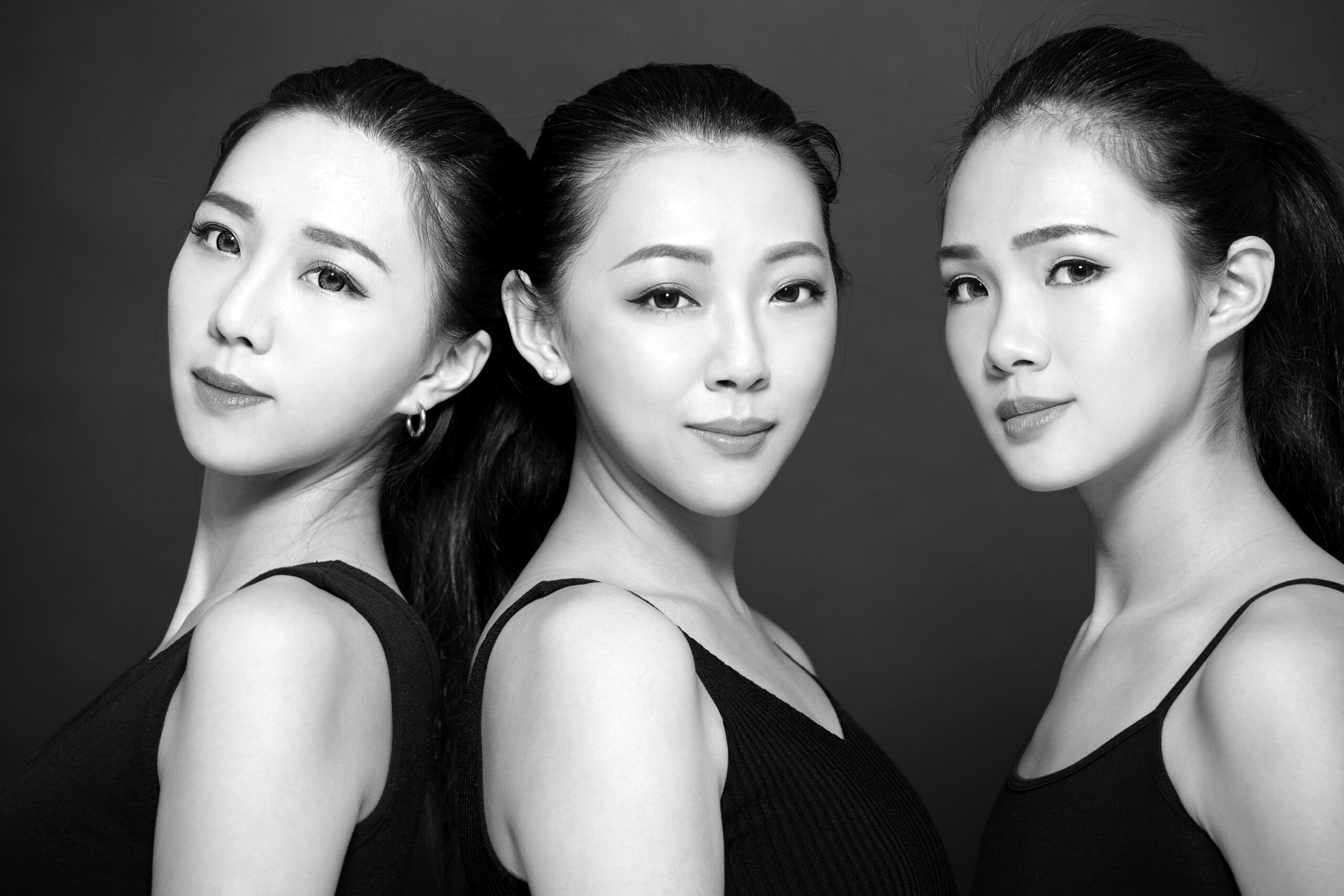 Three asian young beauty on black background