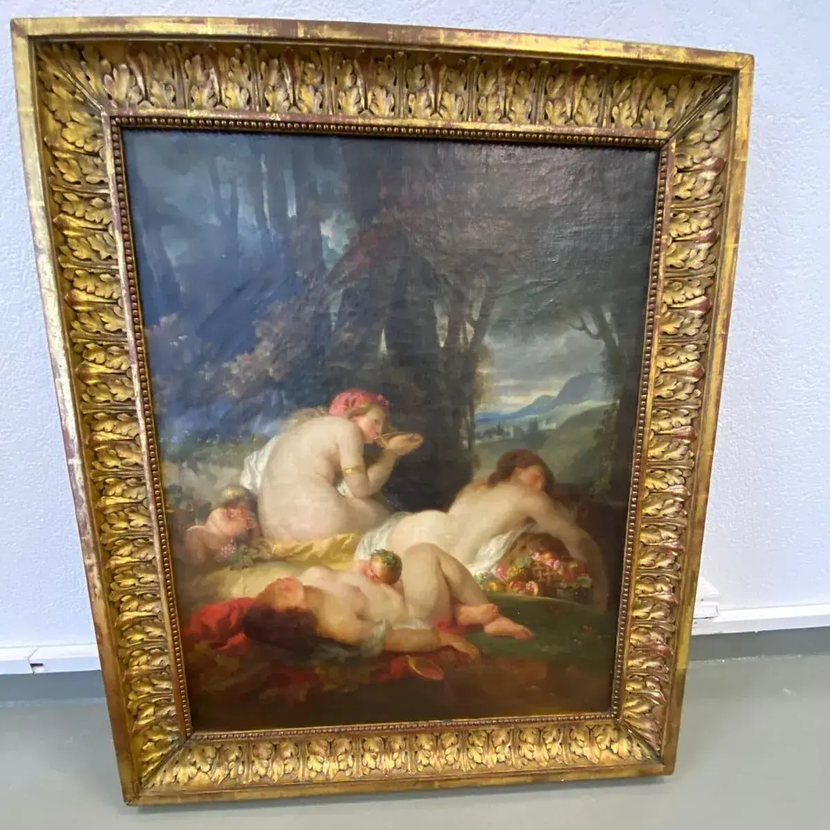 Tableau classique de nus allongés dans un paysage.