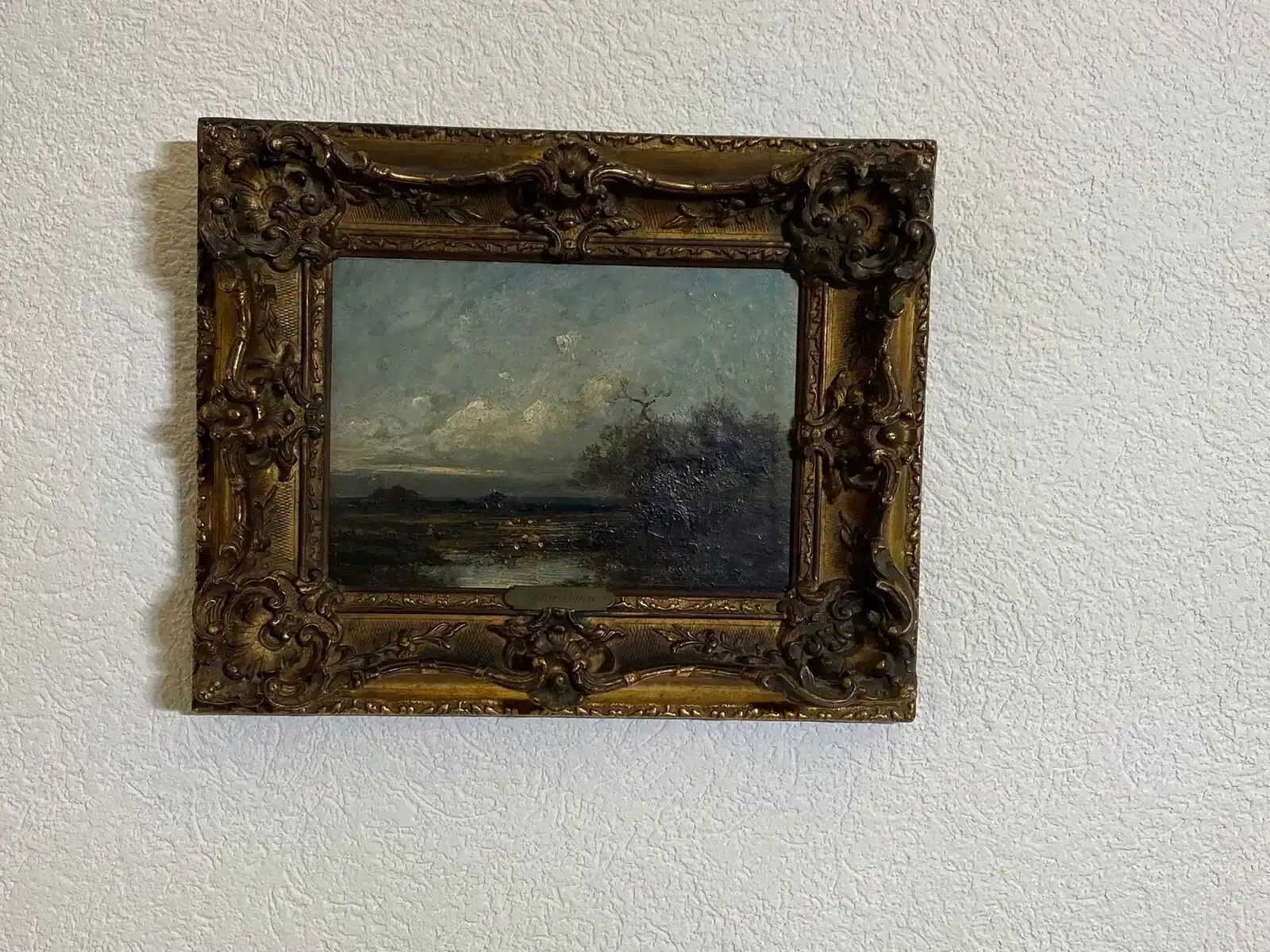 Peinture de paysage sombre avec cadre doré orné
