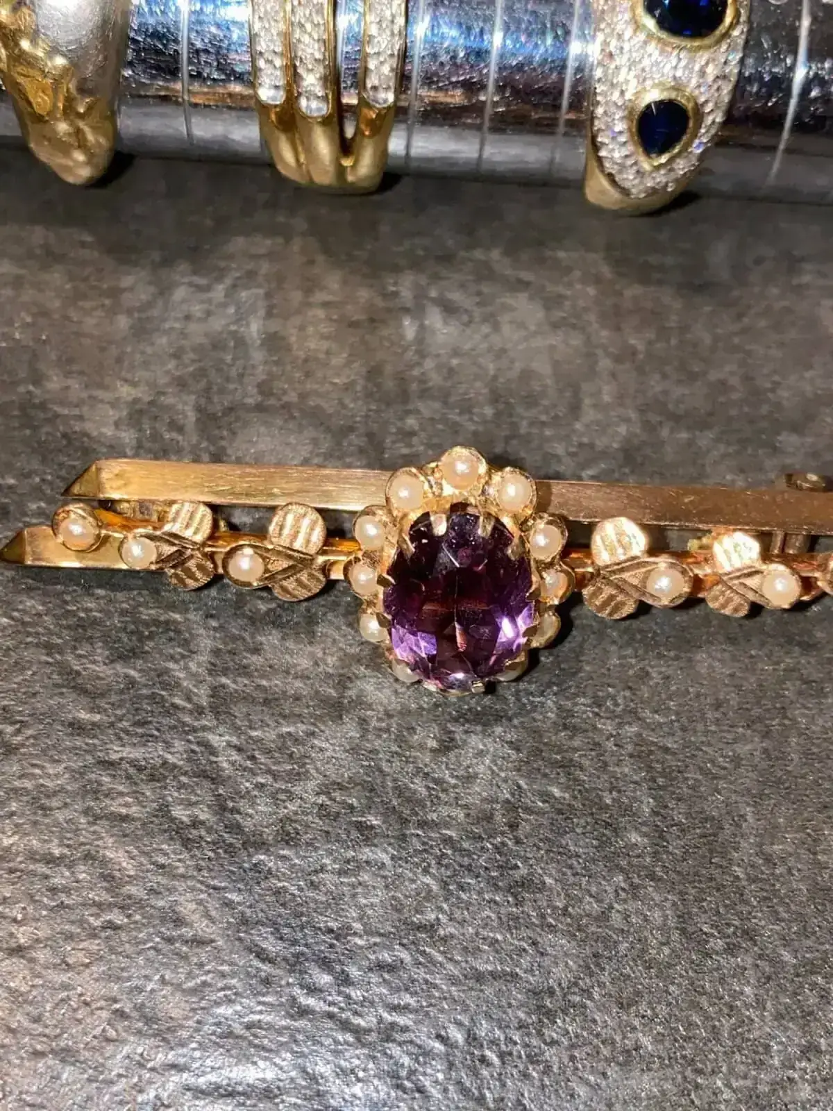 Broche dorée avec pierre violette et perles