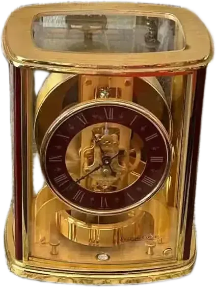 Horloge de table dorée sous cloche en verre