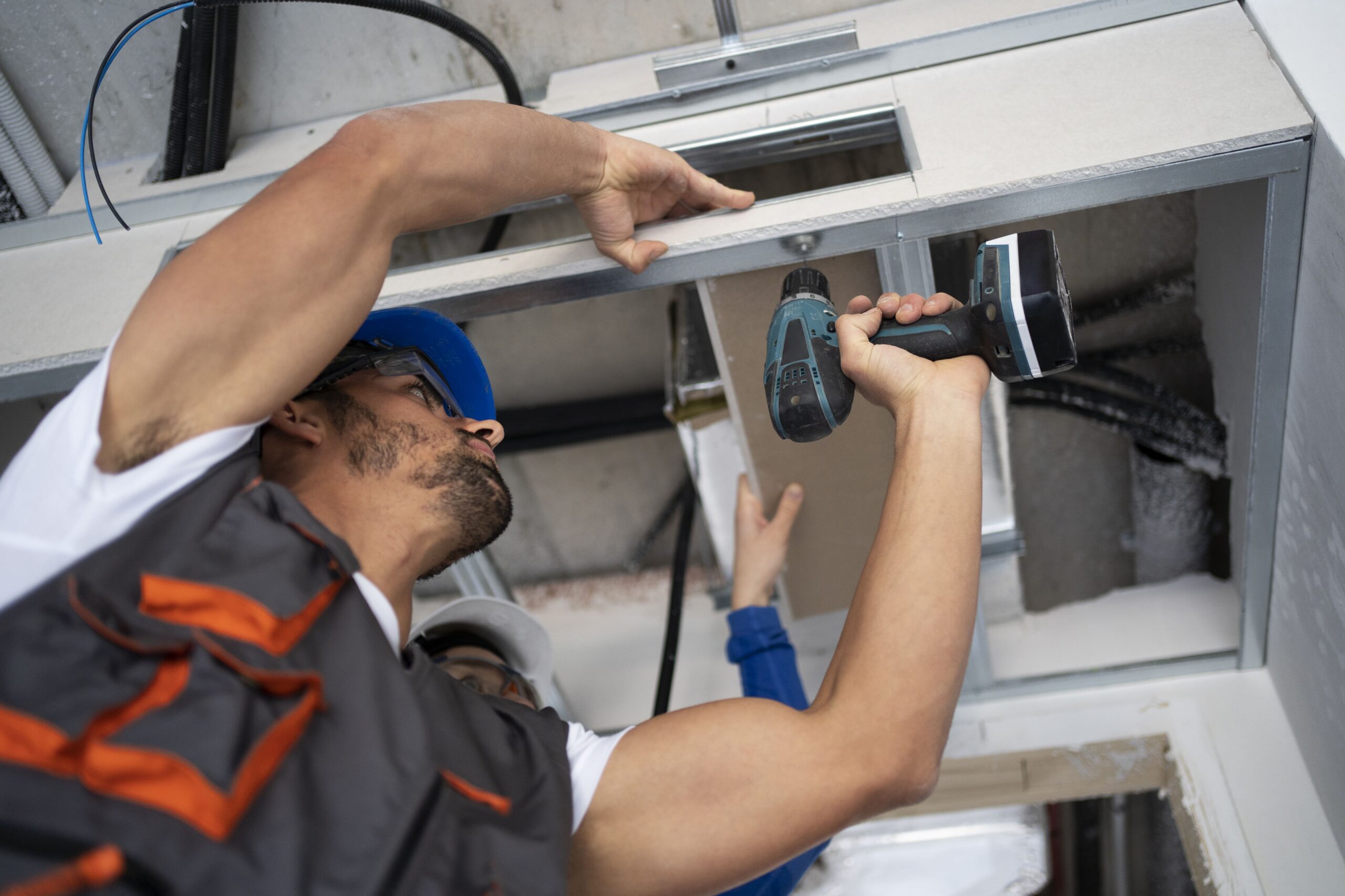 low-angle-people-working-with-drill 1