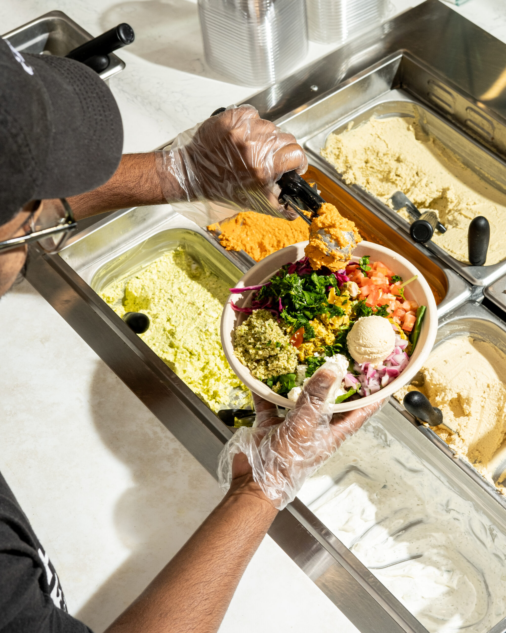 The Questions You Should Be Asking a Franchisor at Discovery Day — and Why Most People Don't A bright Hummus Republic fast casual counter with fresh Mediterranean dishes — the kind of setting serious candidates see when they research how to prepare for a franchise discovery day