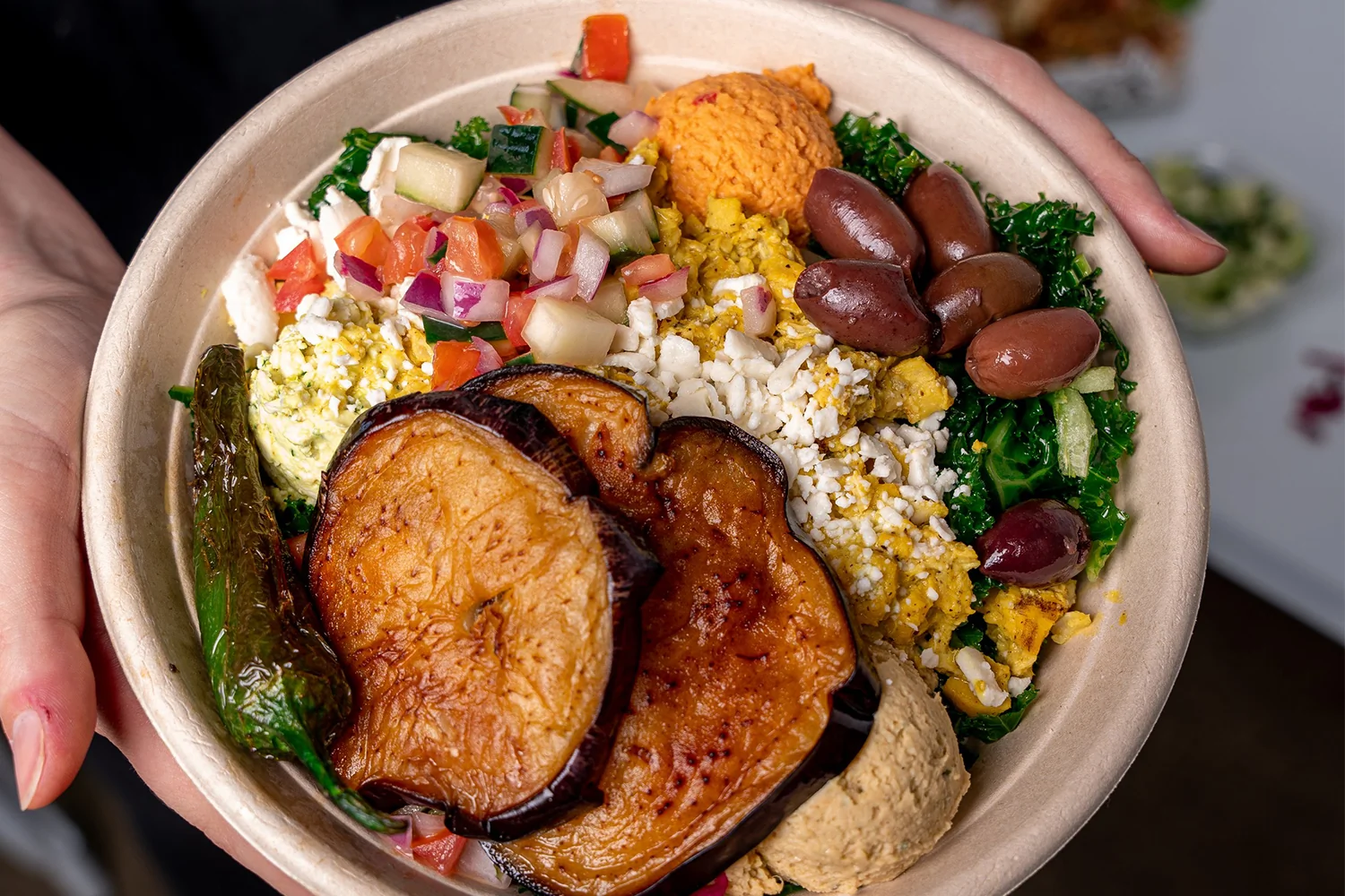 What It Actually Means to Own a Franchise Built Around Food You Already Love Freshly prepared plant forward fast casual franchise bowls with hummus, falafel, and Mediterranean toppings on a clean restaurant counter under warm natural light