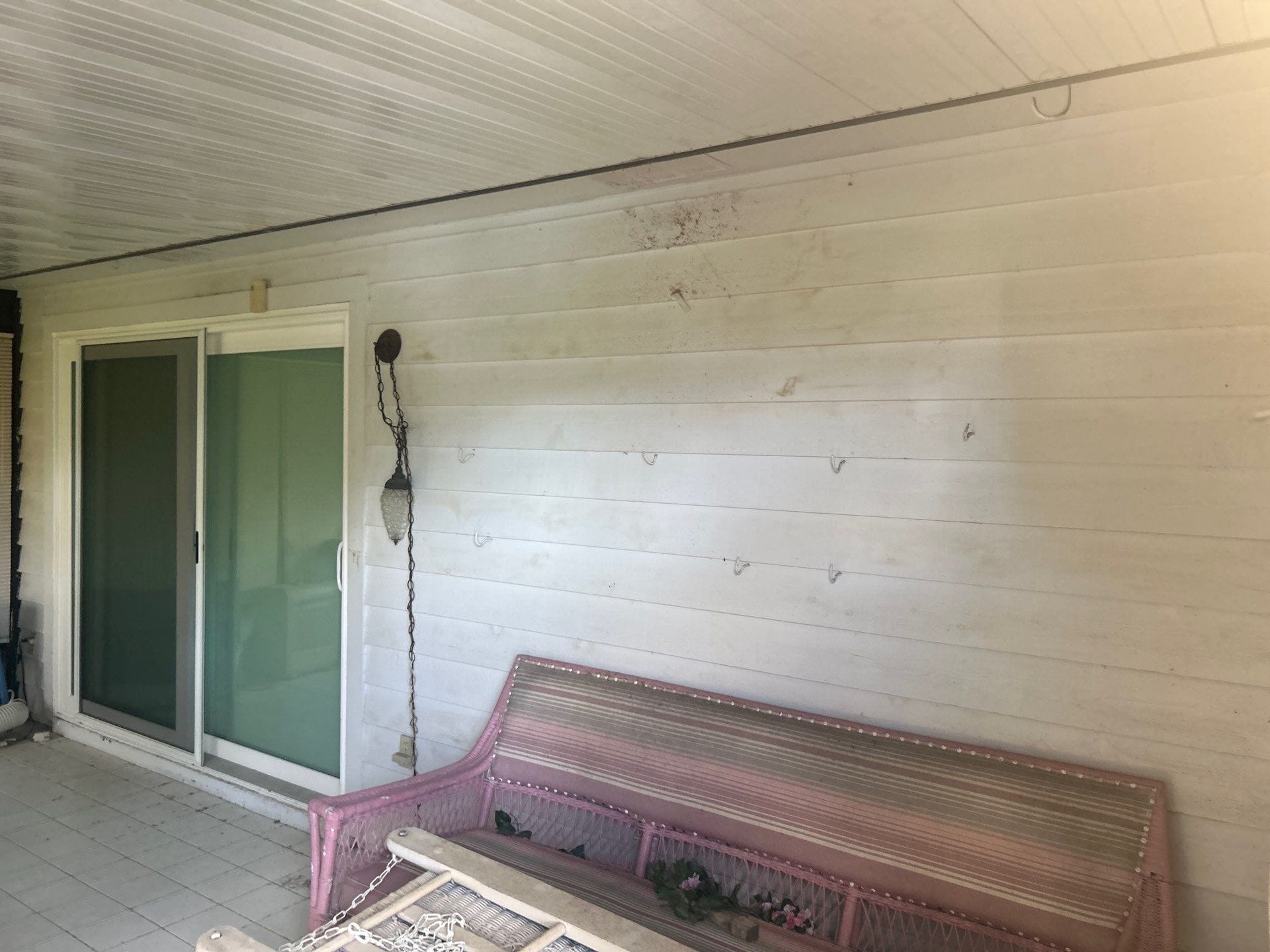 eco-friendly pressure washing Jacksonville - A professional pressure washer cleans a painted surface in Jacksonville, emphasi