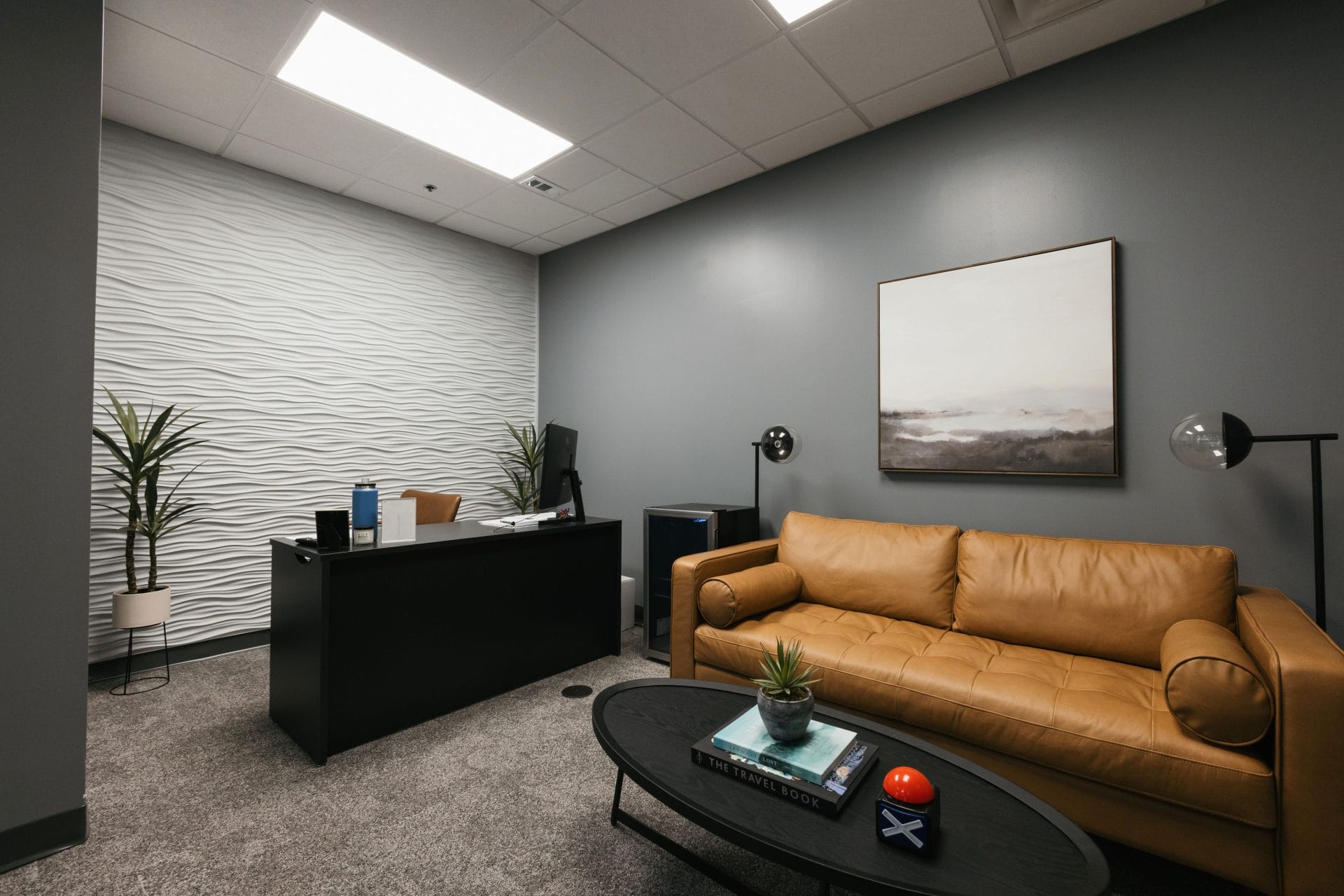 Modern office space with glass walls, sleek furniture, and a collaborative work environment, reflecting contemporary design.