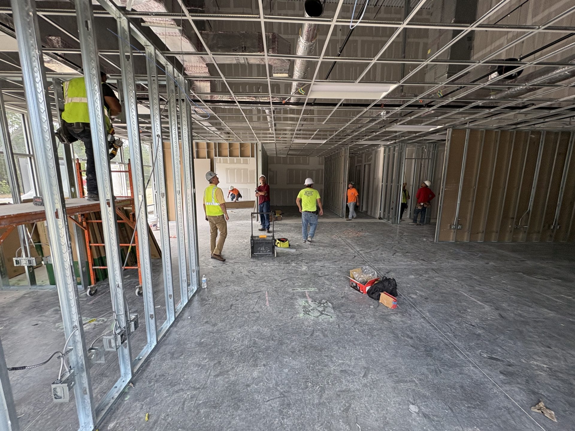 warehouse interior contractor Jacksonville - Spacious warehouse interior with high ceilings and industrial lighting, showcasi