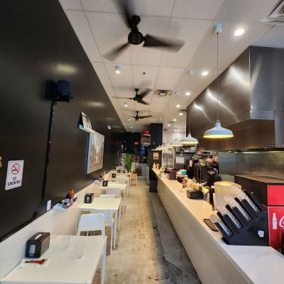 Modern urban Vietnamese dining space with sleek wooden furniture, ambient lighting, and contemporary decor elements.
