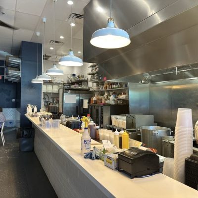 Modern Vietnamese restaurant interior with sleek wooden furniture, ambient lighting, and minimalist decor.