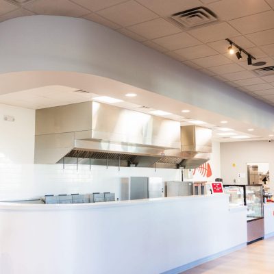 Interior view of a Jacksonville restaurant construction site with exposed beams and wiring, showcasing progress in building.