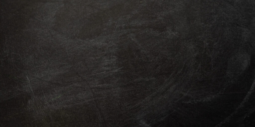 A blank black chalkboard with visible streaks and smudges from previous use, ideal for pairing with chalkboard and whiteboard paint to create versatile, writable surfaces. - Jeff Bryant Painting