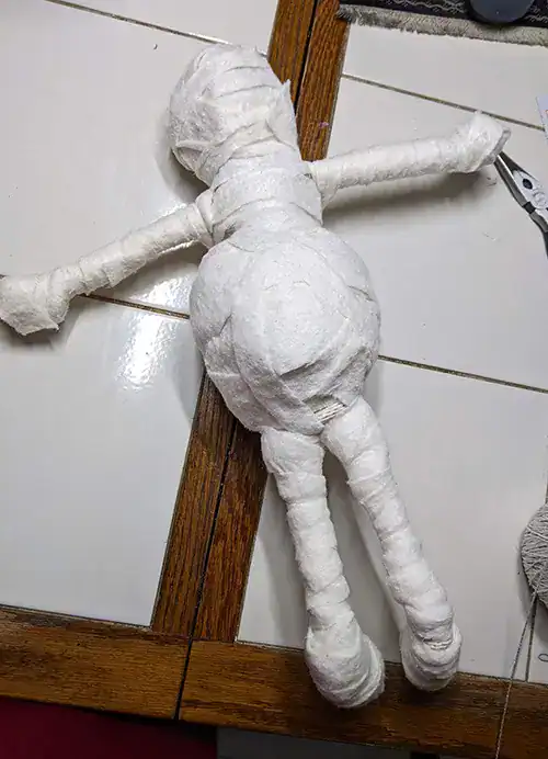 The "Leela" You-Do-You Voodooโข art doll for health and wellness wrapped with soft batting to flesh her out some. A hidden tennis ball forms her belly and butt.