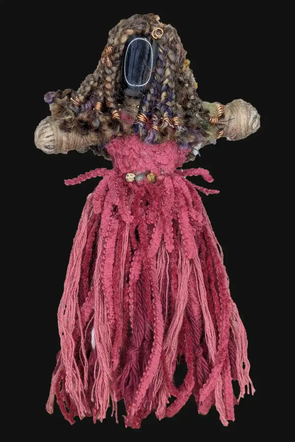 Absynthe Recovery Art Doll featuring a Blue Tigerโs Eye head, Selenite feet, multicolored yarn hair, and a vibrant pink skirt, shown against a black background.