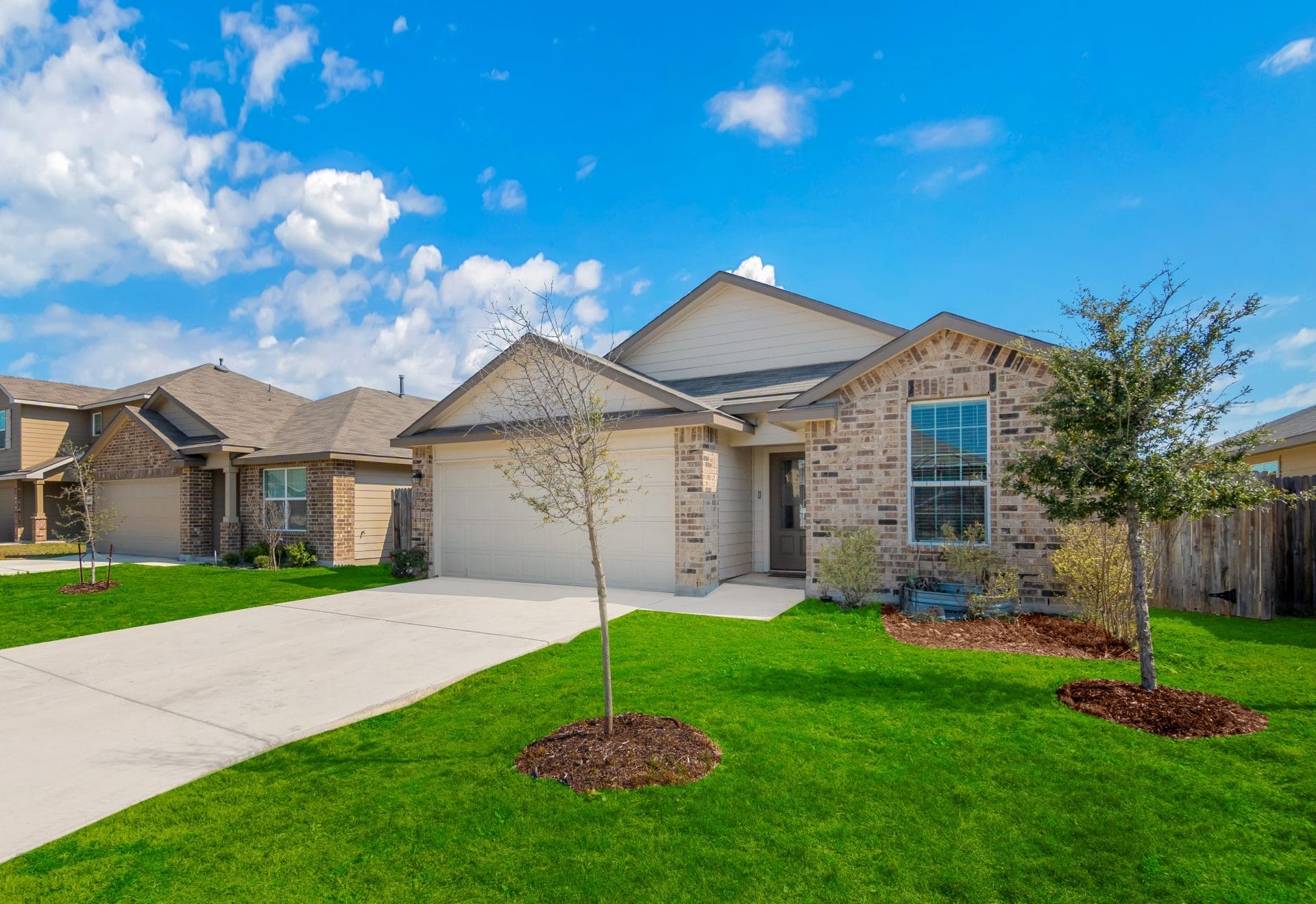 Modern custom home construction Florida with a spacious open floor plan, large windows, and a landscaped front yard.