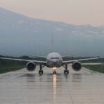 airplane on wet runway taxiing
