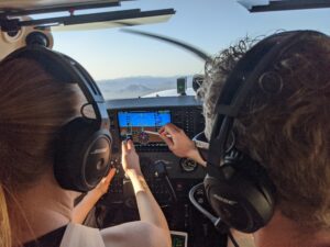 Image of a certified flight instructor giving training in flight.