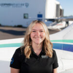 Image of aspiring pilot in front of the Cessna with modern avionics.