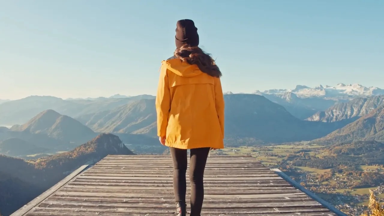 Boost Microbiome Gut Health With Lovebiome P84 &Amp; Protandim 4 Person in yellow jacket standing on a wooden platform looking out over mountains and a valley