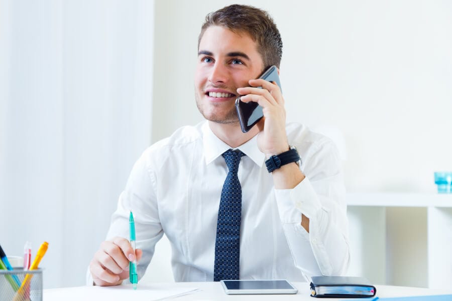 young-handsome-man-working-his-office-with-mobile-phones Man on the phone