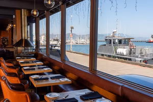 Tables by the window with the harbor in the background