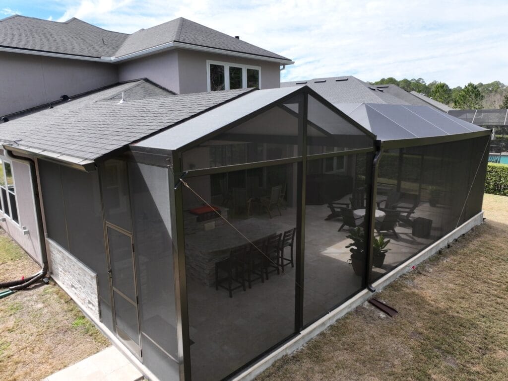 A stylish outdoor seating area shaded by commercial canopies and pergolas, featuring modern furniture on a sunny day.