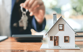 model house with a real estate agent holding a key