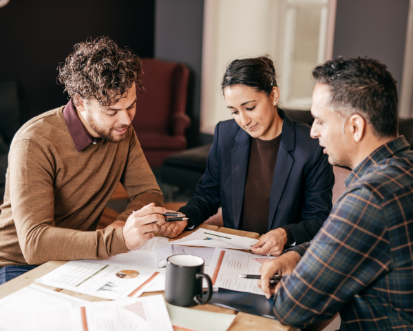 Mortgage Servicer and clients sitting down on a meeting