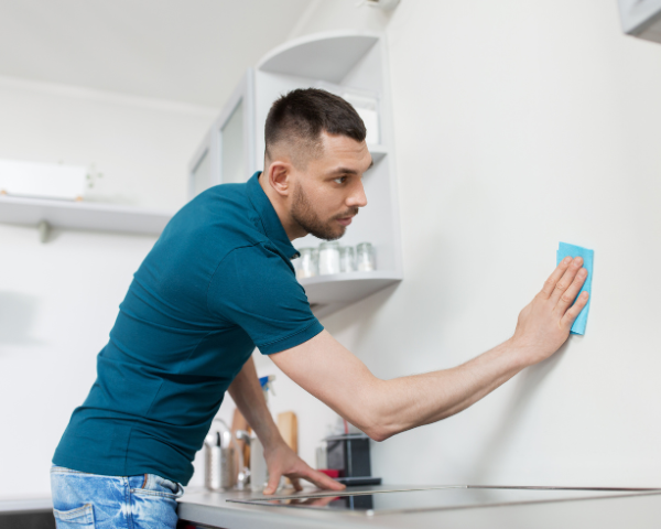 man wiping down the walls