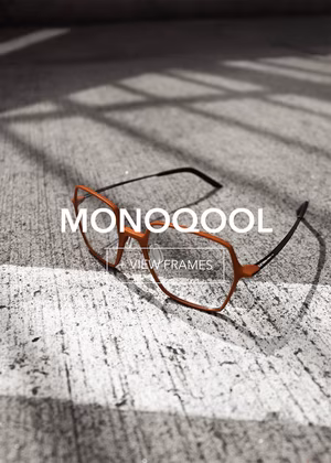 monoqool-final1_3 Angular orange and black eyeglasses on textured concrete. Text: MONOOQOOL, VIEW FRAMES.