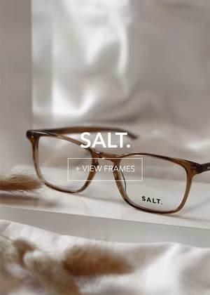 salt-final1_3 Close-up of brown SALT. eyeglasses. Prominent text overlays: 'SALT.' and '+ VIEW FRAMES'.