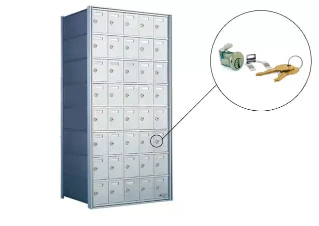 Lost Mailbox Keys A tall silver multi-unit commercial mailbox bank with approximately 40 individual compartments, with a circular inset showing a close-up of a small lock cylinder and two brass keys.